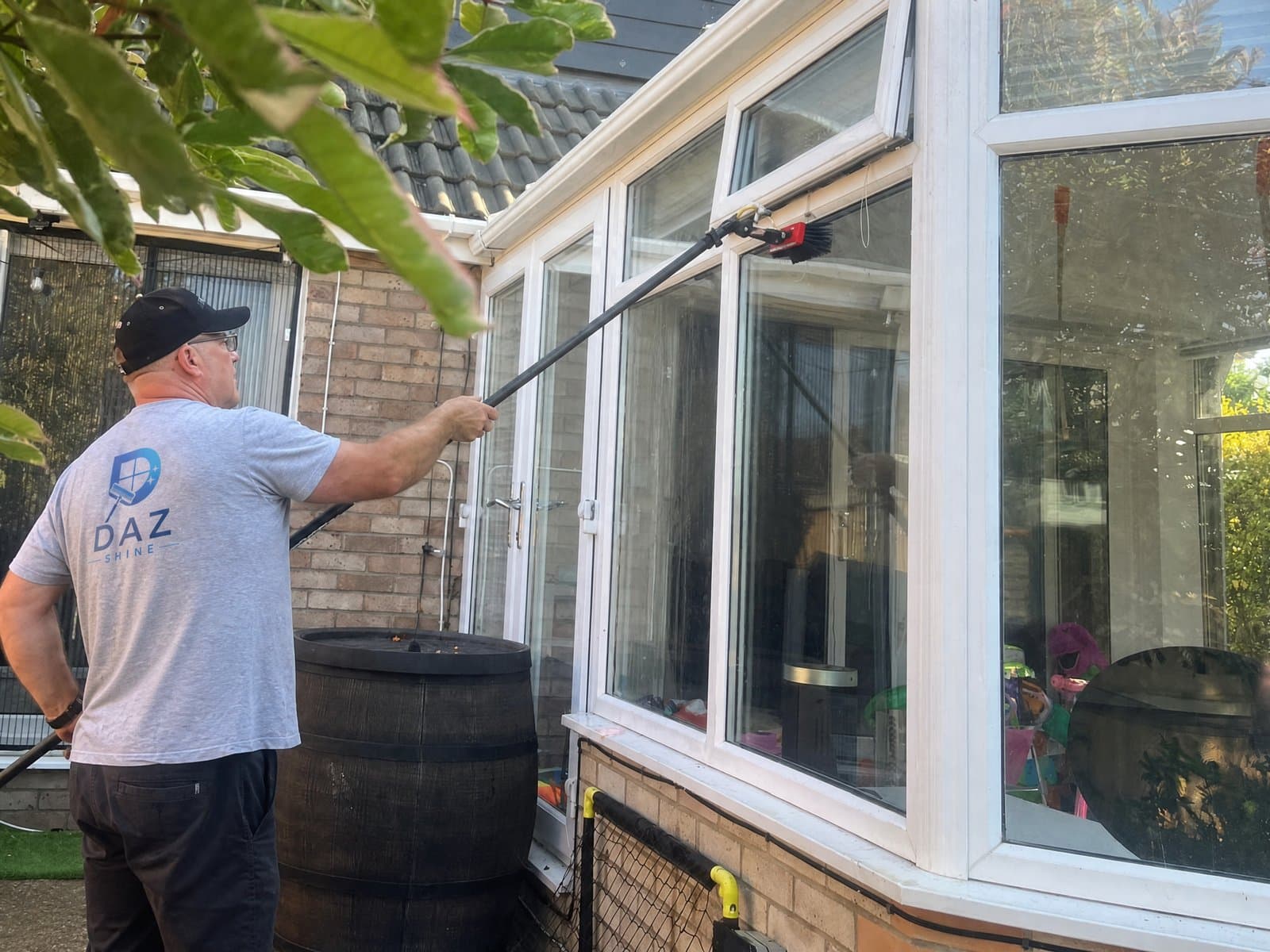 Darren cleaning a conservatory with a water-fed pole at a Bristol home