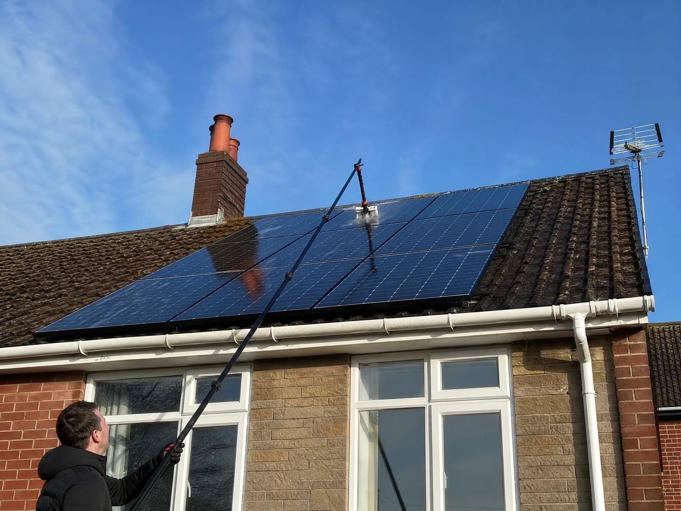 Clean solar panels on a Bristol roof being cleaned with a water-fed pole